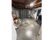 Unfinished garage with an automatic door, exposed ceiling, and laundry area at 9815 Wayside Ln, Port Richey, FL 34668