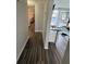 Hallway with wood flooring and a view to the living room and bedroom at 9815 Wayside Ln, Port Richey, FL 34668