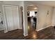Hallway view into the kitchen, featuring sleek flooring and neutral wall colors at 9815 Wayside Ln, Port Richey, FL 34668