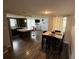 Open kitchen and dining area with island, modern countertops, and stainless steel refrigerator at 9815 Wayside Ln, Port Richey, FL 34668