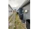 Side yard with partial chain link fence, grassy area, and access door at 9815 Wayside Ln, Port Richey, FL 34668