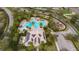 Aerial view showcasing a community pool, clubhouse with solar panels, playground, and ample parking at 10728 Navigation Dr, Riverview, FL 33579
