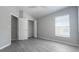 Vacant bedroom featuring modern gray floors, ample natural light, and a closet at 10728 Navigation Dr, Riverview, FL 33579