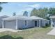 Charming single-story home with a well-maintained lawn and attached two-car garage at 10728 Navigation Dr, Riverview, FL 33579