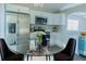 Stylish kitchen featuring stainless steel appliances, modern white cabinetry, and a cozy dining area at 10728 Navigation Dr, Riverview, FL 33579