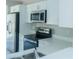 Well-equipped kitchen with stainless steel appliances, white cabinetry, and durable quartz countertops at 10728 Navigation Dr, Riverview, FL 33579