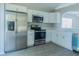 Bright kitchen with stainless steel appliances, white cabinetry, and modern finishes throughout at 10728 Navigation Dr, Riverview, FL 33579