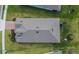 Aerial view of a home's roof and backyard, including a play structure and well-kept lawn and landscaping at 11773 Little River Way, Parrish, FL 34219