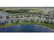High up aerial shot showing houses on a lake with well maintained lawns and landscaping in a planned community at 11773 Little River Way, Parrish, FL 34219