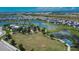 Aerial view of Brightwood's community with scenic pond, lush landscaping, and recreational area at 11773 Little River Way, Parrish, FL 34219