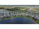 An aerial view of a Primary-planned community on a large lake with manicured lawns and modern home designs at 11773 Little River Way, Parrish, FL 34219