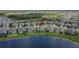 A scenic aerial perspective of a home in a lakeside community, highlighting the serene setting and modern neighborhood design at 11773 Little River Way, Parrish, FL 34219