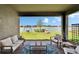 Scenic view of the lake from the covered patio, featuring comfortable seating and a swing at 11773 Little River Way, Parrish, FL 34219