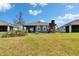 Large backyard featuring a swing set and patio furniture, with scenic views of the adjacent lake at 11773 Little River Way, Parrish, FL 34219