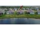 Aerial view of the backyard featuring lake, green grass, and ' playset at 11773 Little River Way, Parrish, FL 34219