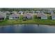 Aerial view of the backyard featuring lake, green grass, and ' playset at 11773 Little River Way, Parrish, FL 34219
