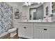 Bathroom with dual sink vanity, framed mirror, toilet and blue-themed decor at 11773 Little River Way, Parrish, FL 34219