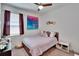Cozy bedroom featuring a ceiling fan, window, and pink decor at 11773 Little River Way, Parrish, FL 34219