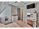 Stylish bedroom with a vanity, TV, and a decorative tree branch accent wall at 11773 Little River Way, Parrish, FL 34219