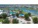 Aerial view showcasing the community playground, pool, and covered picnic areas alongside a tranquil lake at 11773 Little River Way, Parrish, FL 34219