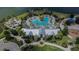Aerial view of Brightwood's community pool and clubhouse with a scenic pool and lush tropical landscaping at 11773 Little River Way, Parrish, FL 34219