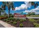 Brightwood at North River Ranch entrance sign with palm trees and blue sky, creating a welcoming atmosphere at 11773 Little River Way, Parrish, FL 34219