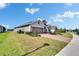Exterior shot showcasing the home's well-manicured lawn, brick driveway, and landscaping at 11773 Little River Way, Parrish, FL 34219