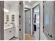 Hallway leading to bedroom and bathroom with gray doors and tile floors at 11773 Little River Way, Parrish, FL 34219