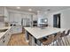Bright kitchen with white cabinets, stainless steel appliances, and a large center island with bar stool seating at 11773 Little River Way, Parrish, FL 34219