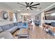 Spacious living room featuring a comfortable sofa and stylish decor, flowing into an open-concept kitchen at 11773 Little River Way, Parrish, FL 34219