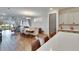 Spacious open-concept living area featuring a dining table, access to lake views, and a modern kitchen island at 11773 Little River Way, Parrish, FL 34219
