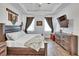 Relaxing main bedroom with a luxurious bed, a decorative tapestry, and natural light, creating a peaceful ambiance at 11773 Little River Way, Parrish, FL 34219
