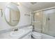 Clean bathroom with a vanity, oval mirror, and glass-enclosed shower at 122 N Kings Ave # 101, Brandon, FL 33510