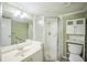 Well-lit bathroom with a single sink vanity, mirrored cabinet, and a framed glass corner shower stall at 122 N Kings Ave # 101, Brandon, FL 33510