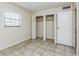 Cozy bedroom features tile flooring, natural light, and closet with ample space for storage at 122 N Kings Ave # 101, Brandon, FL 33510