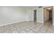 Bedroom features tile flooring, a linen closet, and access to a bathroom with walk-in shower at 122 N Kings Ave # 101, Brandon, FL 33510