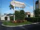 Russellwood Condominiums features beautiful landscaping and a welcoming sign at 122 N Kings Ave # 101, Brandon, FL 33510