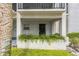 Welcoming entryway with a secure gate, surrounded by vibrant greenery at 122 N Kings Ave # 101, Brandon, FL 33510