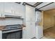 Well-equipped kitchen featuring stove with tile backsplash and laundry appliances at 122 N Kings Ave # 101, Brandon, FL 33510