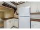 Cozy kitchen with a breakfast bar and a full-size refrigerator at 122 N Kings Ave # 101, Brandon, FL 33510