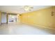 Bright living room with tiled floors, a ceiling fan, and an open view to the kitchen area at 122 N Kings Ave # 101, Brandon, FL 33510
