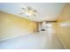 Bright living room features tiled floors, ceiling fan, view into kitchen area and neutral decor at 122 N Kings Ave # 101, Brandon, FL 33510