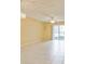 Bright living room with tiled floors, ceiling fan, and sliding glass doors leading to outdoor space at 122 N Kings Ave # 101, Brandon, FL 33510
