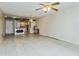 Spacious living room with tile flooring, ceiling fan, and open access to the kitchen area at 122 N Kings Ave # 101, Brandon, FL 33510