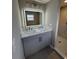 Elegant bathroom boasts double sinks, illuminated mirror, quartz counters, and a walk-in shower at 12801 College Hill Dr, Hudson, FL 34667