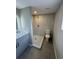 Well-lit bathroom features walk-in shower, toilet, single sink, and updated vanity at 12801 College Hill Dr, Hudson, FL 34667