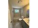 Clean bathroom features a tub, a window, and stylish vanity and fixtures at 12801 College Hill Dr, Hudson, FL 34667