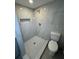 Beautiful bathroom offers a large walk-in shower with marble tiling and new toilet at 12801 College Hill Dr, Hudson, FL 34667