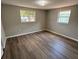 Bedroom features hardwood floors, neutral paint, and plenty of natural light at 12801 College Hill Dr, Hudson, FL 34667