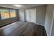 This bedroom has new hardwood floors and a large window with views of the backyard at 12801 College Hill Dr, Hudson, FL 34667